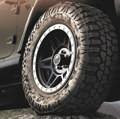 A close up photo of the Terra Trac M/T tire on a charcoal colored car that is off-road somewhere.