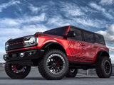 A Red Ford Bronco with the TIS logo and featuring TIS wheels 