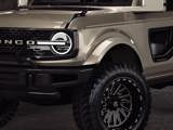 A close up photo of the TIS UT1 tire on a grey off road vehicle in a showroom. 