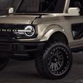 A close up photo of the TIS UT1 tire on a grey off road vehicle in a showroom. 