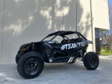 A black UTV featuring the hashtag #TEAMTIS sits outside