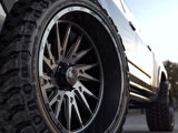 A close-up of the TIS-TT1 With a TIS OFFROAD wheel on a white Toyota Tundra